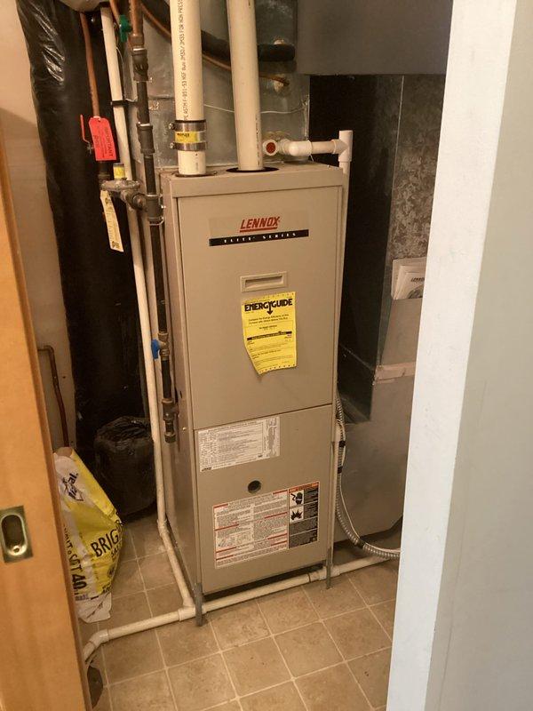 Performed comprehensive furnace inspection for home sale, examining heat exchanger with camera and confirming no cracks or holes present. Located and tightened loose Fernco coupler on exhaust pipe that was dripping water above furnace. All tests completed successfully with CO readings at 0.0 ppm in air stream; furnace deemed in good operational condition for its age.