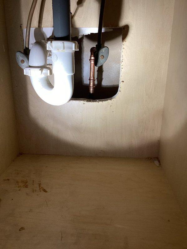 Responded to an emergency leak where water was penetrating from an upstairs bathroom to the lower level. Diagnostic inspection revealed a pin-hole leak in the cold water supply line to the lavatory, with significant copper pipe corrosion evident. Successfully repaired the issue by cutting out the deteriorated section of pipe and installing a replacement connection.