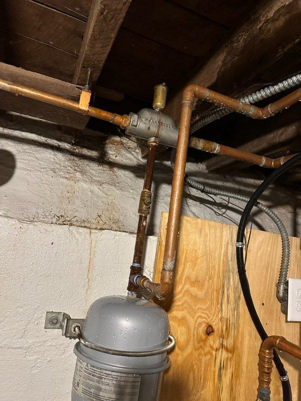 Responded to customer-reported water leak in basement. Diagnosed failed auto vent that had blown apart causing significant water spray and accumulation. Replaced auto vent and discovered system pressure issues related to a failing expansion tank with visible water leakage from its base. System was restored to operation but customer advised that expansion tank replacement is urgently needed to prevent recurrence of pressure problems and ensure proper system function.