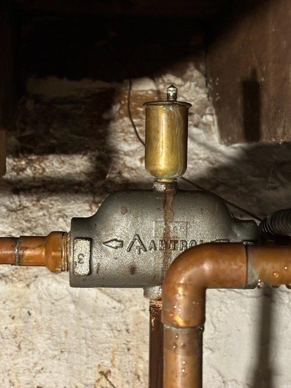 Responded to customer-reported water leak in basement. Diagnosed failed auto vent that had blown apart causing significant water spray and accumulation. Replaced auto vent and discovered system pressure issues related to a failing expansion tank with visible water leakage from its base. System was restored to operation but customer advised that expansion tank replacement is urgently needed to prevent recurrence of pressure problems and ensure proper system function.