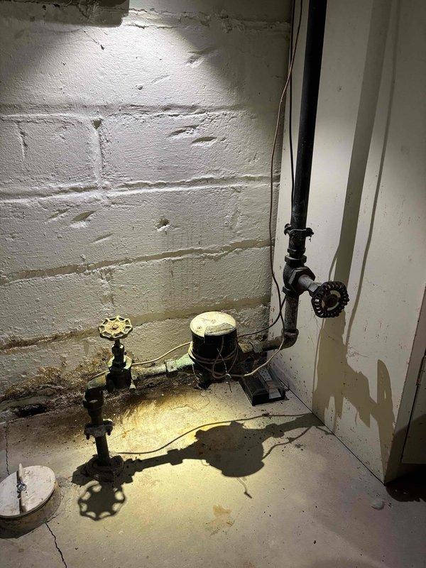 Replaced main water valves in basement plumbing system to address low water pressure issue. City water was restored without notification during service. Scheduled to return Monday morning when customer can arrange proper water shutoff to complete installation.