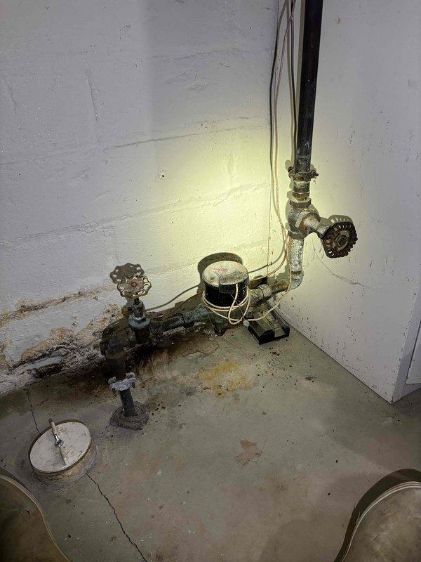 Replaced main water valves in basement plumbing system to address low water pressure issue. City water was restored without notification during service. Scheduled to return Monday morning when customer can arrange proper water shutoff to complete installation.