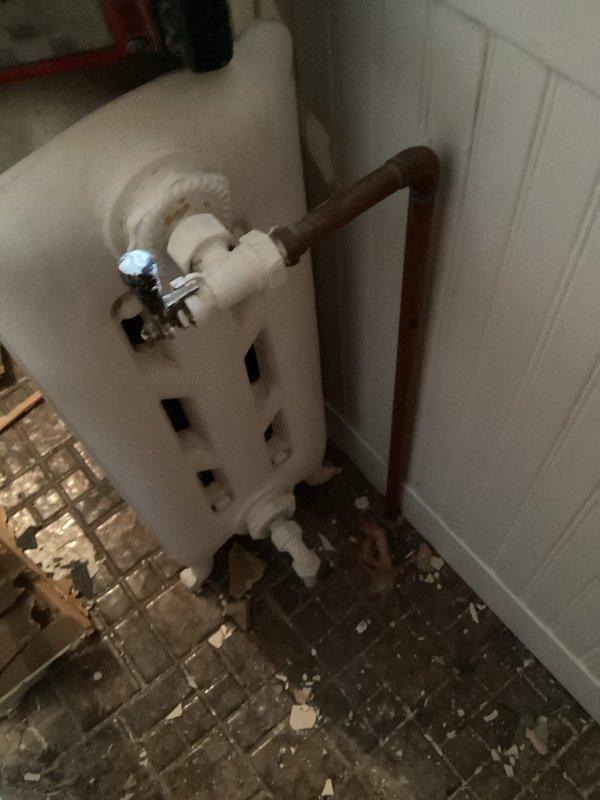 Performed complete steam boiler tuneup including cleaning of burners and burner box, inspection of heat exchanger, piping, gauges, gas pressure, and combustion air. Added water to system and flushed return side. Removed a radiator from upstairs bathroom and capped the lines. Noted missing backflow preventer and recommended replacement of main level radiator valves. Provided information on upgrading to a hydronic high-efficiency boiler system.