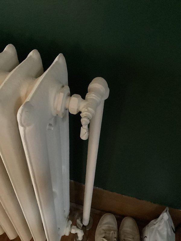 Performed complete steam boiler tuneup including cleaning of burners and burner box, inspection of heat exchanger, piping, gauges, gas pressure, and combustion air. Added water to system and flushed return side. Removed a radiator from upstairs bathroom and capped the lines. Noted missing backflow preventer and recommended replacement of main level radiator valves. Provided information on upgrading to a hydronic high-efficiency boiler system.