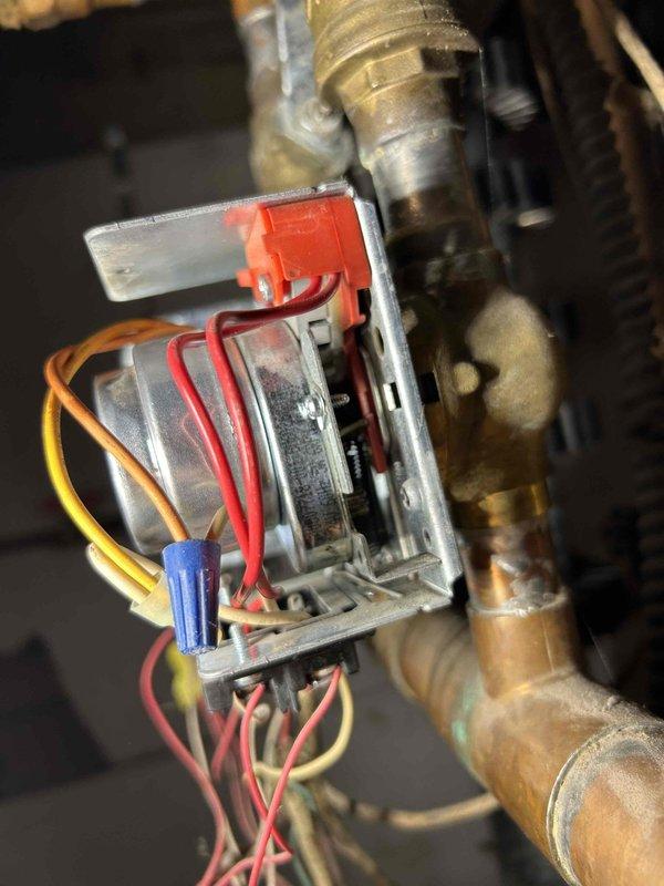 Responded to service call for a Weil-McLain boiler system where the second floor zone was overheating and would not shut off except via breaker. Diagnostic inspection revealed a stuck zone valve for the second floor. Manually closed the valve by removing the motor head and depressing the spring mechanism. Disconnected wiring to prevent reopening. First floor heating remains operational while second floor heating is currently disabled until replacement zone valve motor can be installed. Customer signature obtained for future zone valve head replacement.