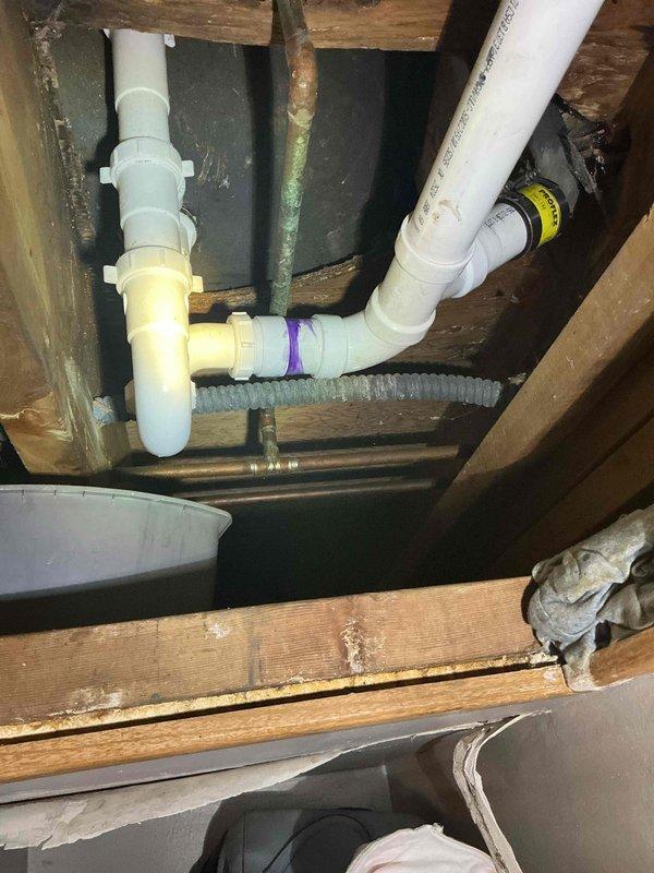 Responded to return service call for tub drain leakage that was previously serviced. Inspected P-trap assembly in crawlspace, identified insufficient lubrication causing seal failure. Applied proper lubrication to P-trap connection, verified complete resolution of leak with no further seepage observed.