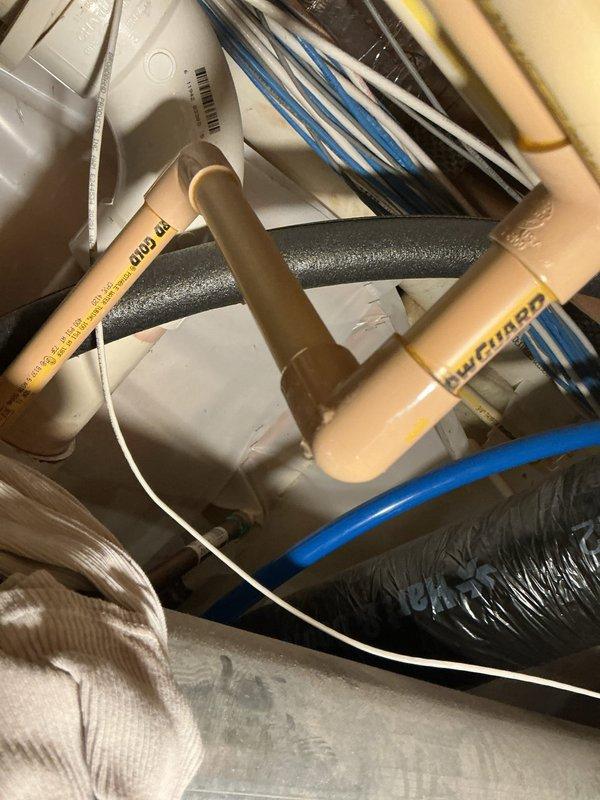 Responded to service call for a leaking 50-gallon natural gas water heater (2016 model) exhibiting Fault Code 2 issues. Diagnosed failed pressure relief valve causing T&P discharge and damaged CPVC connections. Replaced faulty pressure valve and repaired compromised CPVC piping sections, restoring proper system operation and eliminating leakage.