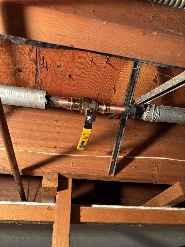 Diagnosed and resolved outdoor spigot control issue by locating and installing a new shutoff valve for front hose bib. Installed copper piping with brass fittings and a yellow handle shutoff valve, properly secured to joists with metal brackets for optimal accessibility and function.