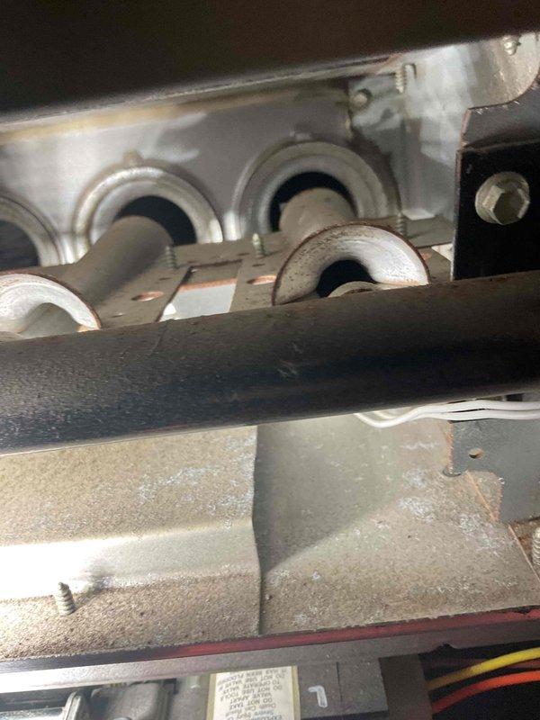 Performed scheduled tune-up on 15-year-old furnace to ensure proper operation and efficiency. Visual inspection revealed rust developing on heat exchanger, with photos documenting the condition of burner assembly and evaporator coil. Customer reported slight squeaking noise from fan which was noted for monitoring. Advised customer to keep watch on heat exchanger condition due to visible corrosion.