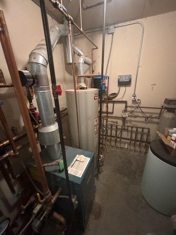 Replaced corroded 15-year-old LP water heater with new A.O. Smith ProMax model to prevent potential leaking. Installation included proper connection of copper supply lines and venting system in utility room. Customer declined recommendation for assessment of potential combi boiler unit that could service both domestic water and existing boiler system.