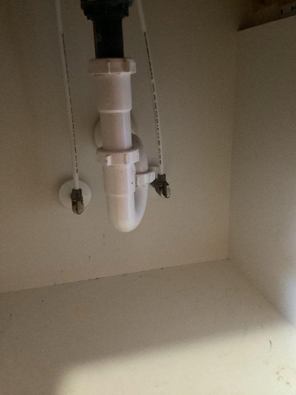 Installed customer-supplied bathroom vanity faucet and kitchen faucet per specifications. Completed P-trap assembly with proper drain connections and installed flexible supply lines. No warranties provided on customer-supplied materials as per company policy.