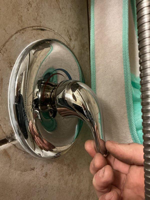 Returned to resolve an issue with previously installed tub spout that failed to adhere properly to wall. Found spout approximately 2.5 inches from wall with significant leakage due to failed caulking and an improperly pressed coupling. Completely re-piped line from valve to spout, secured spout to wall with proper sealing, and tightened handle assembly to ensure proper function.