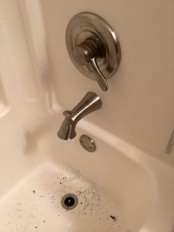 Diagnosed customer-reported leak from spout and installed customer-supplied tub shower valve, spout, and head assembly. Completed installation through existing access panel behind valve. No warranty provided on customer-supplied parts as per company policy.