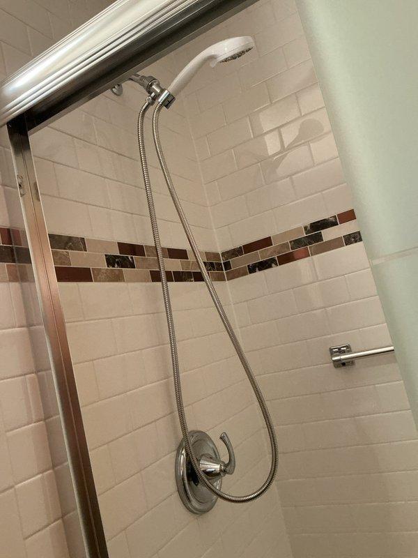 Diagnosed and replaced faulty shower cartridge to resolve persistent shower faucet leak in bathroom. Inspected plumbing connections including copper pipes and brass valves for potential additional issues. Discussed water heater options with customer as part of comprehensive service evaluation.