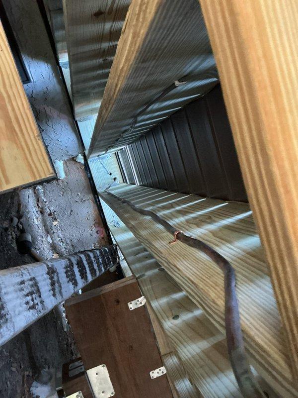 Responded to service call for damaged gas line running from house to outdoor grill. Upon inspection, found the gas line had been kinked and burred during deck construction. Accessed the confined space between wooden framing to examine the damage, then successfully completed gas line repair to restore safe operation.