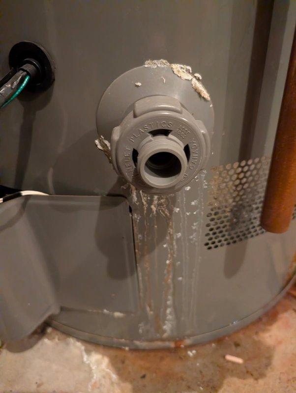 Diagnosed and repaired a leaking water softener system installed in 2017. Upon inspection, found water damage at base of unit and identified the drain connection to tank as the source of leakage. Replaced the damaged plastic drain assembly which had significant mineral buildup and sealed the connection properly to resolve the issue.