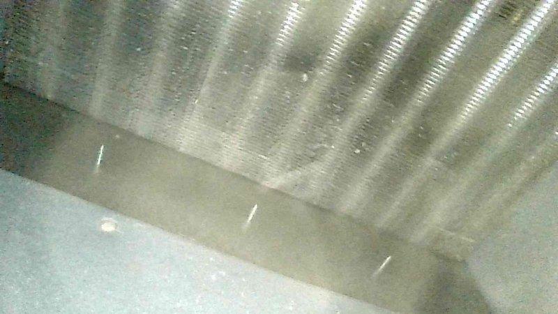 Responded to no-heat call for 15-year-old LP furnace with symptoms of failure to ignite and blower continuing to run. Diagnosed tripped rollout switch and observed oversized flames between burners. Extracted burners for cleaning, adjusted inter-burner spacing, and inspected heat exchanger which showed no concerning conditions. Upon reassembly and restart, furnace operated normally with proper ignition and heating cycles.