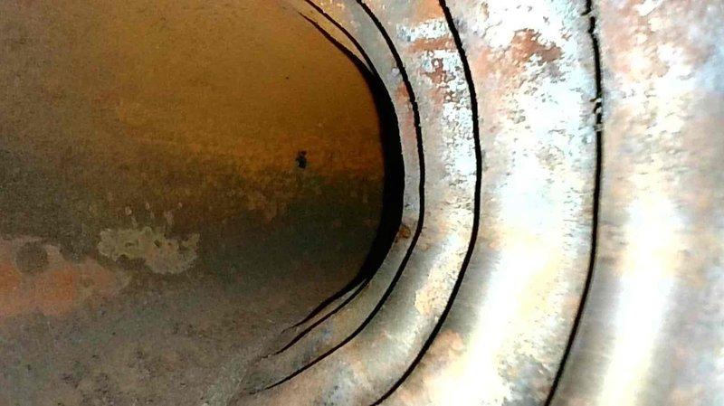 Responded to no-heat call for 15-year-old LP furnace with symptoms of failure to ignite and blower continuing to run. Diagnosed tripped rollout switch and observed oversized flames between burners. Extracted burners for cleaning, adjusted inter-burner spacing, and inspected heat exchanger which showed no concerning conditions. Upon reassembly and restart, furnace operated normally with proper ignition and heating cycles.