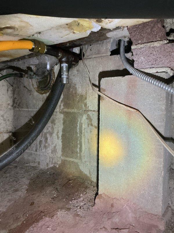 Responded to emergency gas leak call at property. Located a cracked 3/4" x 1/2" brass bushing in the crawl space gas line connected to boiler. Replaced damaged fitting to restore gas line integrity.