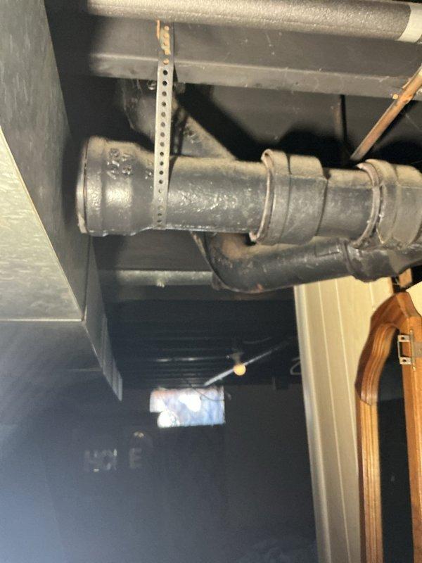 Addressed leak at residence caused by deteriorating bathtub waste and overflow assembly. Inspection revealed swelling and active leakage at the shut hub connection between floors. Successfully replaced damaged section of waste and overflow components, restoring proper drainage function and eliminating water intrusion to basement ceiling.