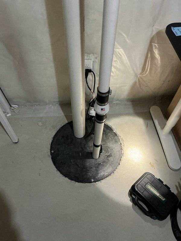 Responded to service call regarding a continuously running sump pump with suspected condensation or leakage on the discharge pipe. Upon inspection, determined the issue was caused by either an air lock in the system or a malfunctioning check valve. Verified the sump pump installation including PVC piping configuration and proper electrical connections to restore normal operation.