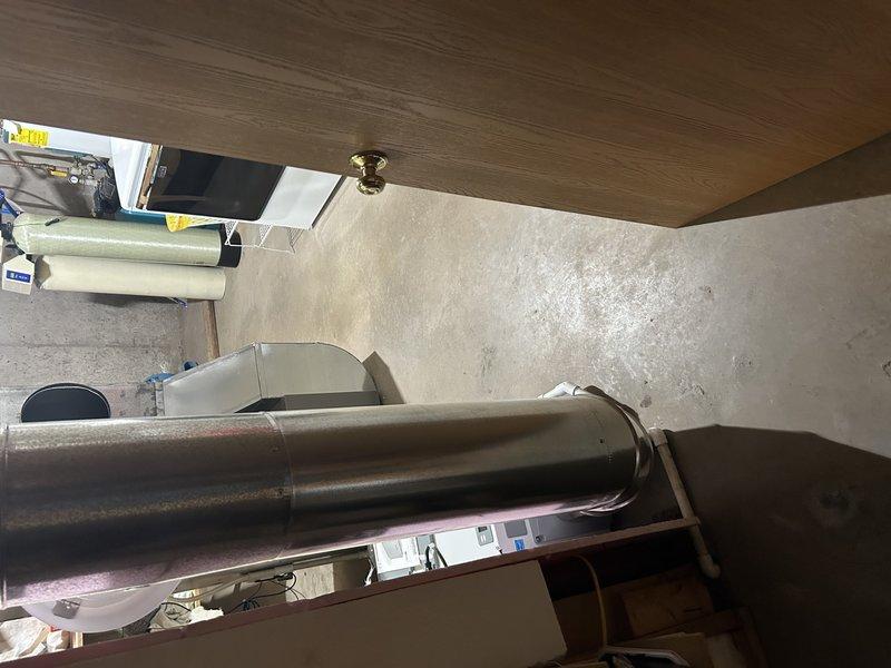 Evaluated ongoing dehumidifier installation issues in basement where customer expressed concerns about restricted access to mechanical/laundry room area. Documented current installation configuration showing dehumidifier placement and 10-inch round ductwork connection to return that blocks doorway. Assessed options for repositioning dehumidifier adjacent to furnace, which would require reworking ductwork and drain line to improve accessibility while maintaining proper system function.