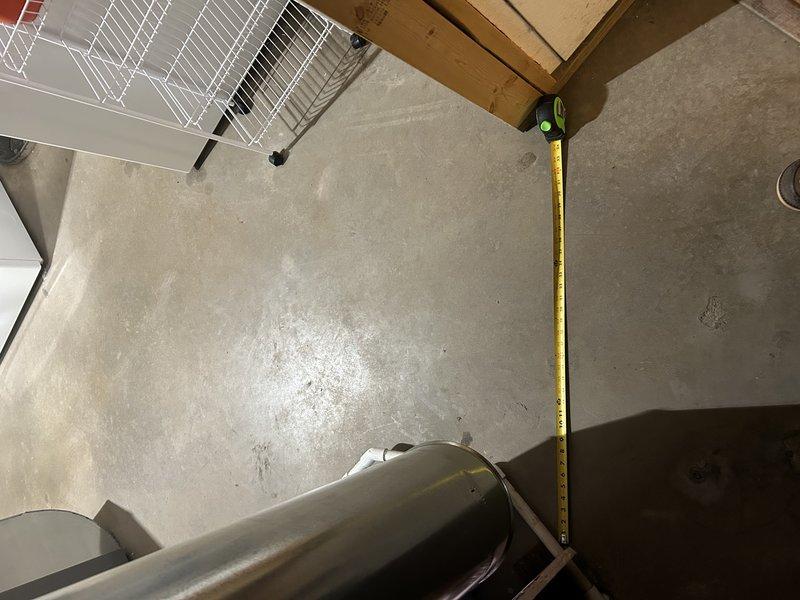 Evaluated ongoing dehumidifier installation issues in basement where customer expressed concerns about restricted access to mechanical/laundry room area. Documented current installation configuration showing dehumidifier placement and 10-inch round ductwork connection to return that blocks doorway. Assessed options for repositioning dehumidifier adjacent to furnace, which would require reworking ductwork and drain line to improve accessibility while maintaining proper system function.