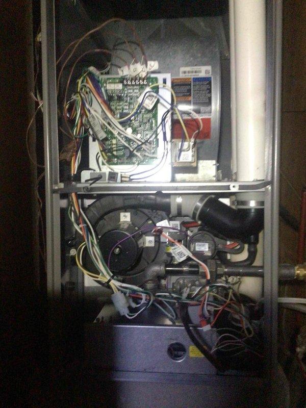 Replaced warranty circuit board in Lennox furnace that was damaged by water intrusion from a freezing AC coil. Identified 2002 AC unit that has history of freezing issues and requires relocation to improve system configuration on downflow furnace. Recommended replacement of aging AC unit rather than relocation due to age and ongoing performance problems.