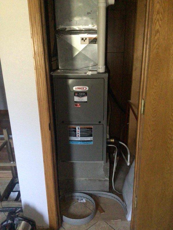 Replaced warranty circuit board in Lennox furnace that was damaged by water intrusion from a freezing AC coil. Identified 2002 AC unit that has history of freezing issues and requires relocation to improve system configuration on downflow furnace. Recommended replacement of aging AC unit rather than relocation due to age and ongoing performance problems.