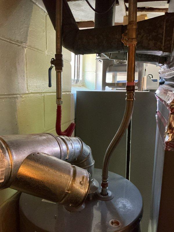 Installed water line connection for a humidifier system utilizing a tee fitting. Successfully completed the repipe work above the heating unit, ensuring proper water supply to the humidifier. All connections were secured and tested for proper function.