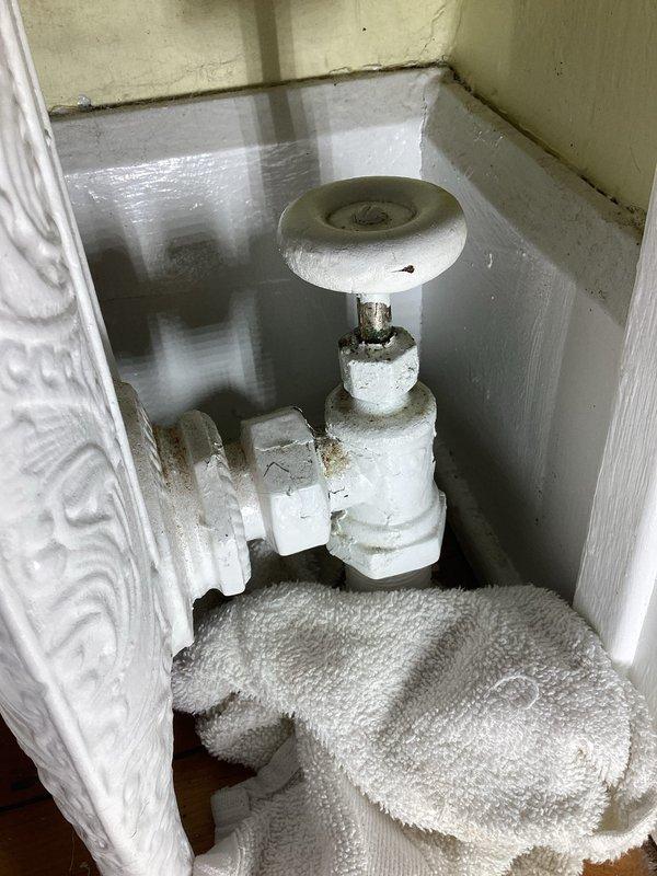 Responded to service call for boiler system with active leak. Identified faulty packing in radiator valve causing water to escape at the elbow joint. Documented condition with photos and provided customer with estimate for valve replacement. Customer advised to contact when ready to proceed with repairs.