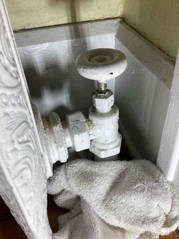 Responded to service call for boiler system with active leak. Identified faulty packing in radiator valve causing water to escape at the elbow joint. Documented condition with photos and provided customer with estimate for valve replacement. Customer advised to contact when ready to proceed with repairs.