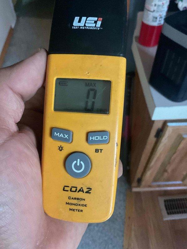 Responded to no heat service call for a 15-year-old furnace. Diagnosed system with green light flashing and blowing cold air. Inspection revealed a cracked ignitor requiring replacement. Performed carbon monoxide safety testing with UEi meter, confirming zero CO emissions after repair. Customer advised about ductwork issues under mobile home, which they will address separately.