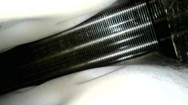 Responded to no-heat call for aging system where temperature was set to 70°F but only reaching 66°F. Diagnostic inspection revealed clogged condensate drain line backing up into the inducer motor. Service performed included clearing obstructed drain line, which restored proper system operation and heat production.