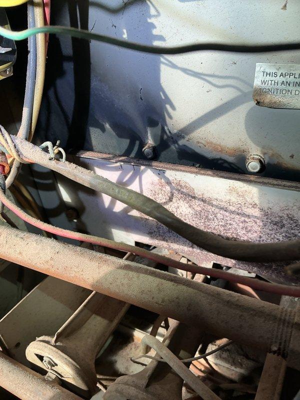 Responded to service call for 40-year-old furnace with severe operational issues. Diagnosed multiple critical safety concerns including 70-80 PPM carbon monoxide leakage from front of unit, flame rollout during ignition, oil leakage from deteriorating blower motor, and unstable squirrel cage causing grinding and rattling noise. System was shut down for safety due to dangerous CO levels and aging components beyond serviceable condition.