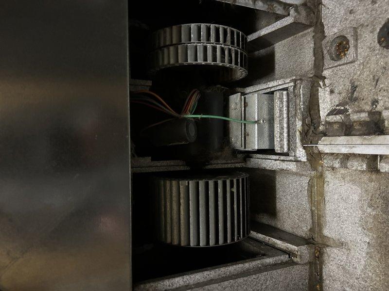 Diagnosed non-functional air exchanger on recently installed furnace. Confirmed voltage is reaching motor but no operation observed. Inspected dual-blower assembly and found motor unresponsive. Customer advised of parts needed for repair and provided alternative replacement options.