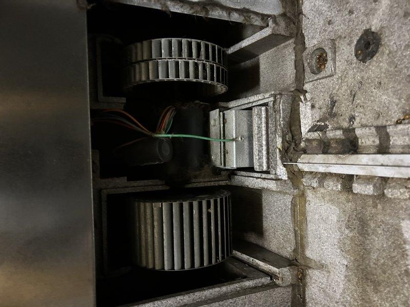 Diagnosed non-functional air exchanger on recently installed furnace. Confirmed voltage is reaching motor but no operation observed. Inspected dual-blower assembly and found motor unresponsive. Customer advised of parts needed for repair and provided alternative replacement options.