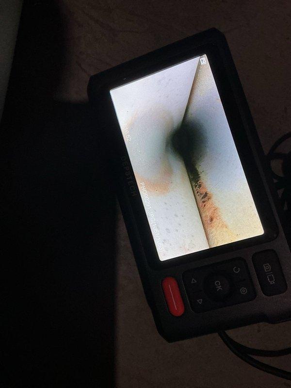 Performed routine maintenance on 13-year-old LP furnace. System exhibited dust accumulation; cleaned flame sensor and inspected interior components with borescope. Discovered non-functional humidifier which customer declined to repair. Verified system is operating correctly post-service.