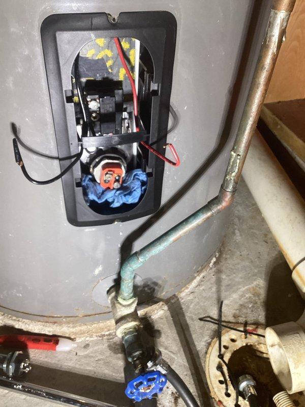 Diagnosed and repaired Vanguard 80-gallon electric water heater that was only providing warm water after customer's well shock treatment. Accessed electrical components, replaced thermostats and elements to restore proper heating function. Provided customer with options for both repair and replacement of the unit.