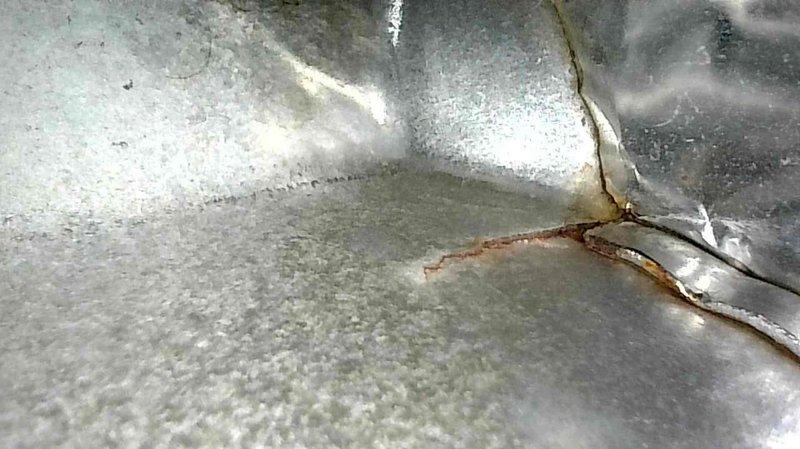 Performed annual LP furnace maintenance inspection and identified multiple cracks in the heat exchanger along with holes in the side wall, documented with detailed photos of the metal degradation and staining. Due to the compromised heat exchanger integrity, replacement of the furnace is recommended, with pricing information to follow.