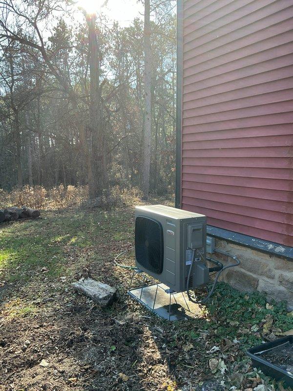 Investigated customer complaint of inaccurate outdoor temperature readings on Lennox thermostat, confirming sensor reads 10-15 degrees higher than actual temperature due to direct sunlight exposure and heat radiation from dark exterior wall. Evaluated thermostat placement concerns related to nearby wood-burning stove causing temperature inconsistencies in distant rooms. Recommended monitoring temperature discrepancies at different times and discussed installation of remote temperature sensors to improve comfort in rooms affected by uneven heating.