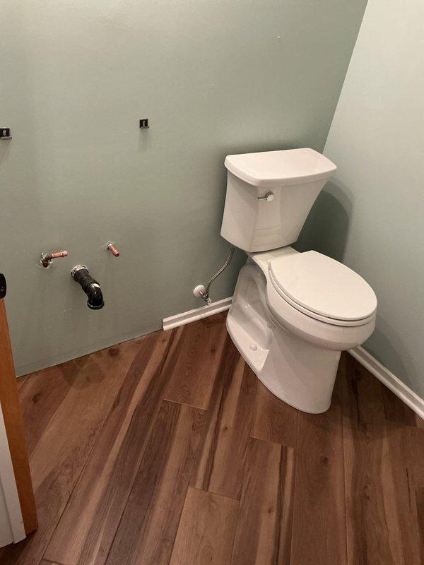 Completed installation of customer-supplied vanity and two toilets in bathroom renovation, including installation of new shutoff valves. Connected water supply lines and ensured proper drainage function. Left one toilet with exposed plumbing connections to be completed on scheduled return visit.