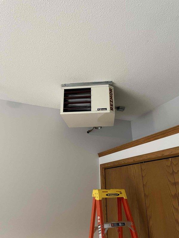 Responded to no-heat call for Reznor wall-mounted heater in garage. Diagnosed failed inducer motor exhibiting internal arcing when attempting operation despite receiving power. Temporarily disabled unit for safety to prevent potential fire hazard, and communicated findings to customer via phone.