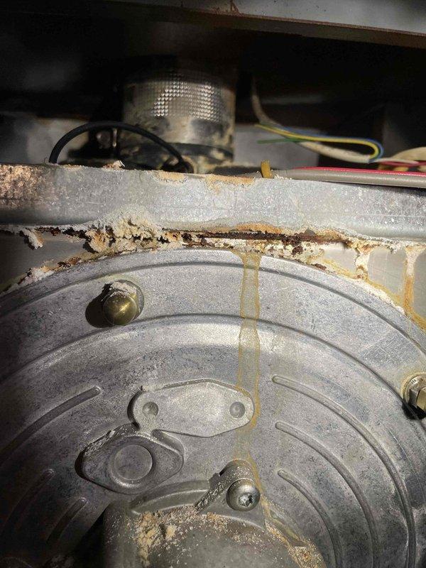 During service call to diagnose overheating boiler (installed 2006), identified a stuck zone valve causing the main floor zone to overheat. Visual inspection revealed exhaust leaking around seams and burner door. Combustion analyzer detected CO levels up to 30ppm throughout the area. Red-tagged boiler as unsafe due to exhaust leakage into home. Noted system requires zone valve replacement and control updates. Advisor scheduled to evaluate repairs.