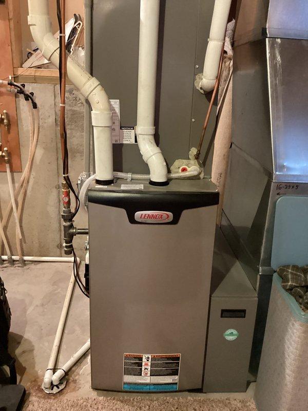 Performed annual furnace tuneup on 1-year-old Lennox system. Identified and repaired exhaust pipe leak by cutting out affected section and regluing. Evaluated furnace operation in both low and high fire modes with satisfactory results. Addressed boiler issue by adjusting Taco 00e-3 circulator pump setting from high to medium, successfully eliminating humming noise. Recommended boiler tech for inoperative in-floor heating system.