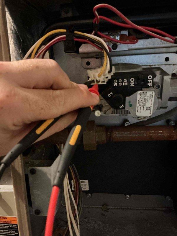 Responded to no heat complaint on 7-year-old Luxaire furnace. Diagnosed system with only one burner igniting during heat call. Upon inspection of burner assembly, found low fire side of gas valve coil was open. Attempted to clean orifices but gas valve subsequently failed to operate. Recommended replacement of gas valve and burner assembly or furnace replacement as alternative solution due to deteriorated condition of burner components.