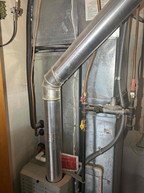Performed comprehensive tune-up on 19-year-old furnace system. Identified and addressed weak flame sensor (reading 1.0-1.2 microamp), which was cleaned and replaced. Service included cleaning burners and orifice, replacing air filters, removing dust and debris buildup, and verifying thermostat connections when intermittent R-wire communication issues were detected. Confirmed safe carbon monoxide levels and proper gas pressure operation.