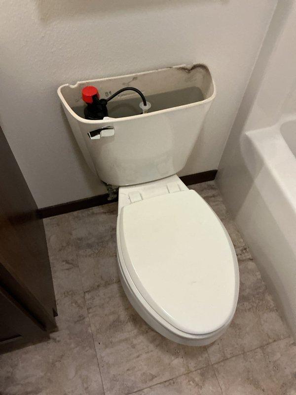 Diagnosed and replaced damaged internal toilet components. Removed tank lid to access and replace broken fitting and malfunctioning flush mechanism. Installation included new toilet "guts" to restore proper operation.