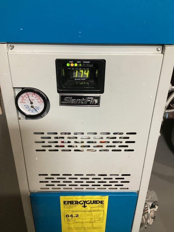 Performed comprehensive tune-up on SlantFin boiler (6 years old). Inspected heat exchanger, cleaned burners, verified flue condition, and checked pump functionality. Found bedroom zone valve defective and replaced it. Adjusted gas pressure, verified combustion air, and cycled system to confirm proper operation. Recommended resealing collector box to prevent exhaust leakage into living space. System now functioning normally with all zones operating correctly.