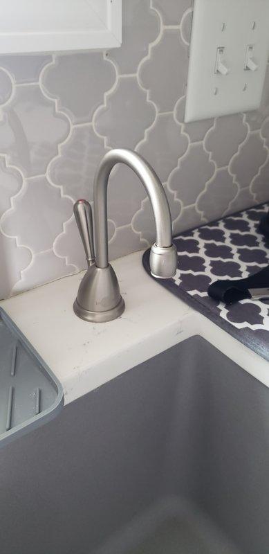 Completed comprehensive plumbing inspection of property focusing on three key issues: non-functioning instant hot water spout at kitchen sink, water softener system, and water heater evaluation. Observed resin deposits in toilets indicating possible water softener malfunction. Documented existing equipment condition with photos and provided customer with detailed recommendations for necessary repairs.